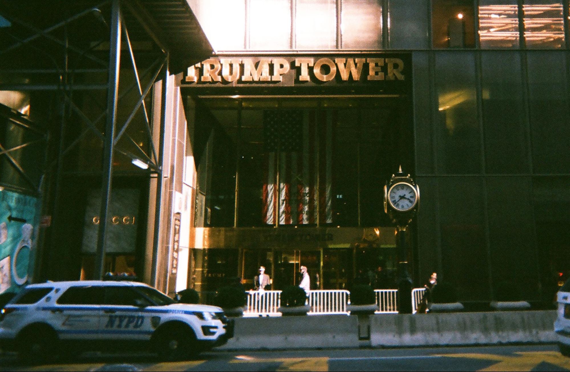 Trump Tower on Fifth Avenue at night, NYPD barriers at the base, Gucci next door